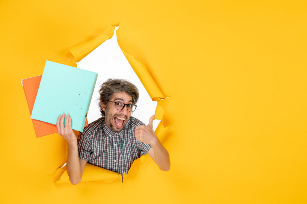 front view young male holding files yellow wall front view young male holding files yellow wall